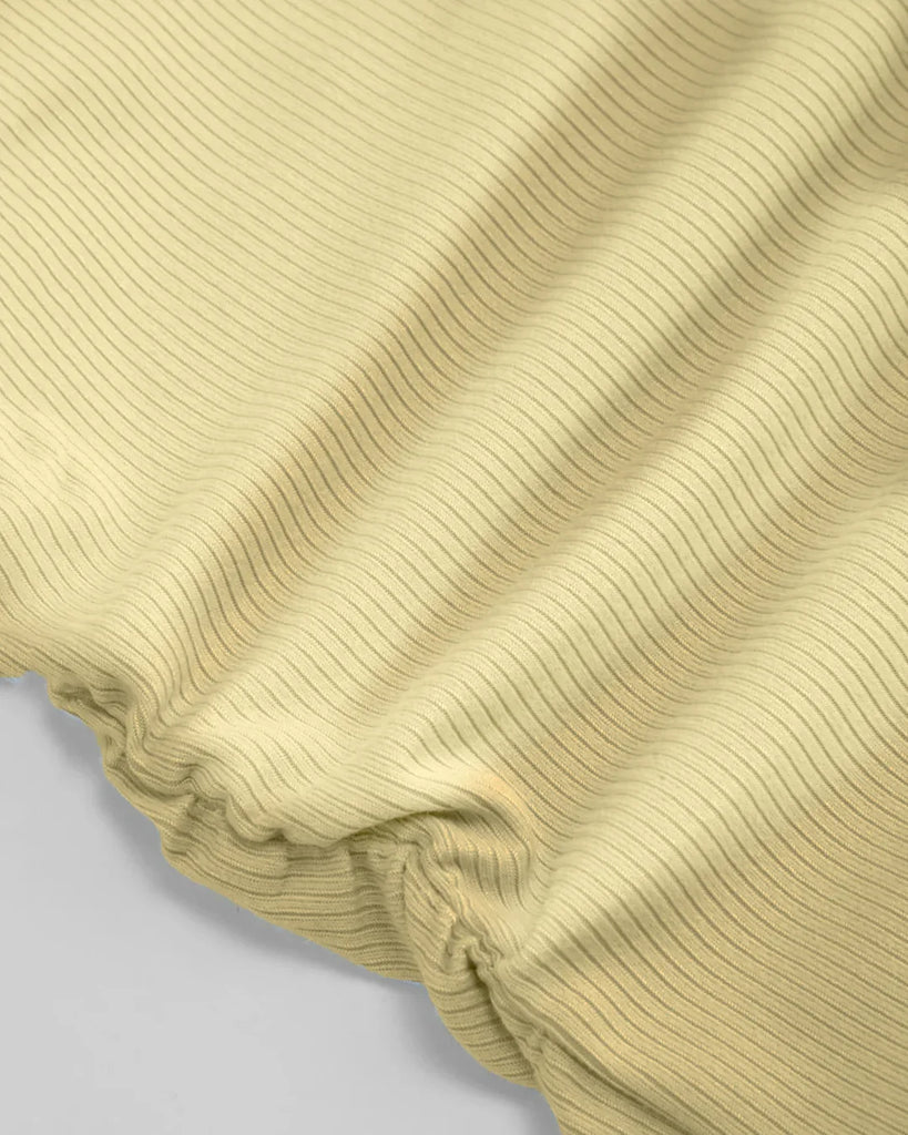 Fabric of yellow sleeveless top with a high neck and ruched side detailing, perfect for a stylish summer look