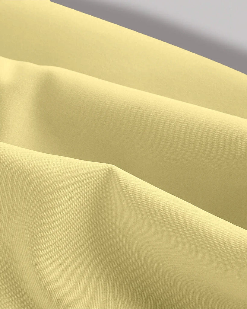 Vanilla sleeveless midi dress featuring side ruched detail, elegantly designed for a stylish look.
