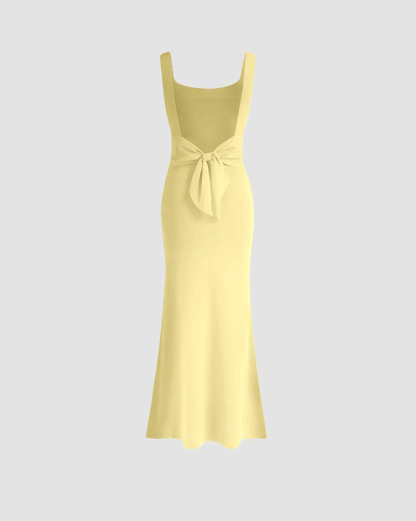 A vanilla bodycon midi dress with a square neckline, featuring a sleek, figure-hugging silhouette from top to hem.
