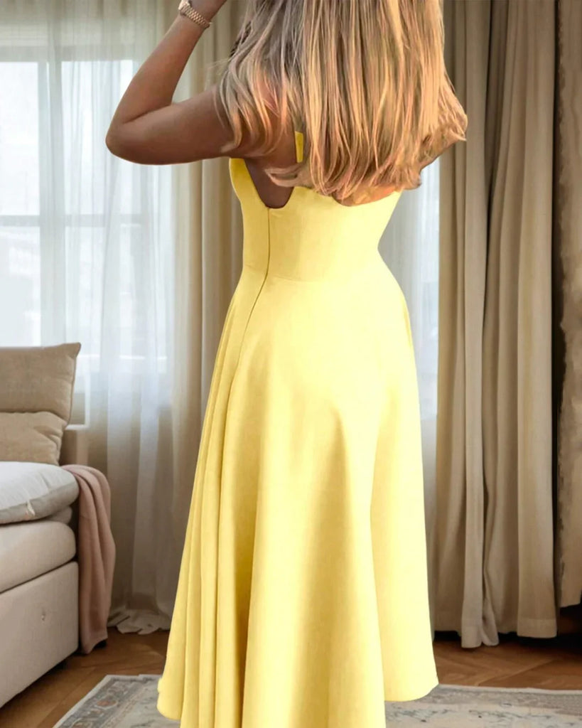 A vanilla yellow strapless fit and flare midi dress with a flared skirt, perfect for adding a touch of sunshine to any occasion.