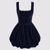 A sophisticated navy blue mini dress crafted from plush velvet, featuring a structured square neckline, a chic knotted detail, and a voluminous bubble silhouette for a refined yet playful look.