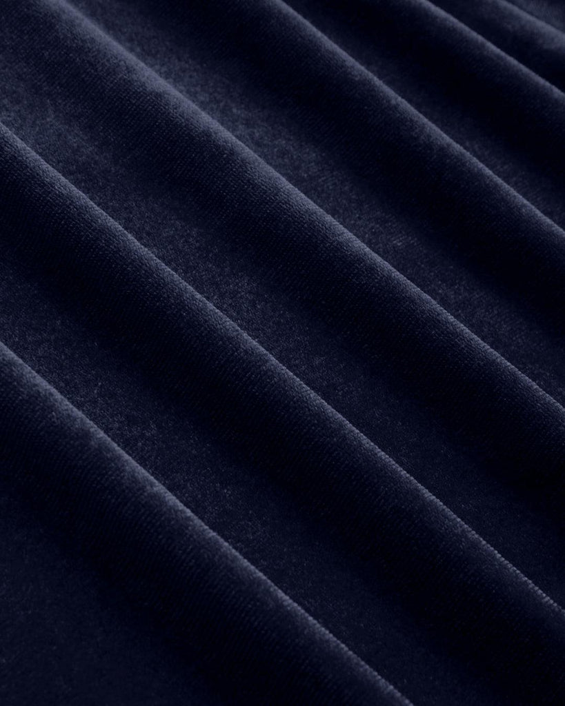 burgundy velvet dress with bow-tie straps, a fitted bodice, knotted maxi dress close up view