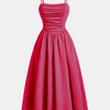 A vintage-inspired pink dress featuring spaghetti straps and a retro silhouette for a timeless, charming look.