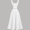 Vintage off-white dress with ruffled shoulders, featuring a sleeveless top and matching skirt set.