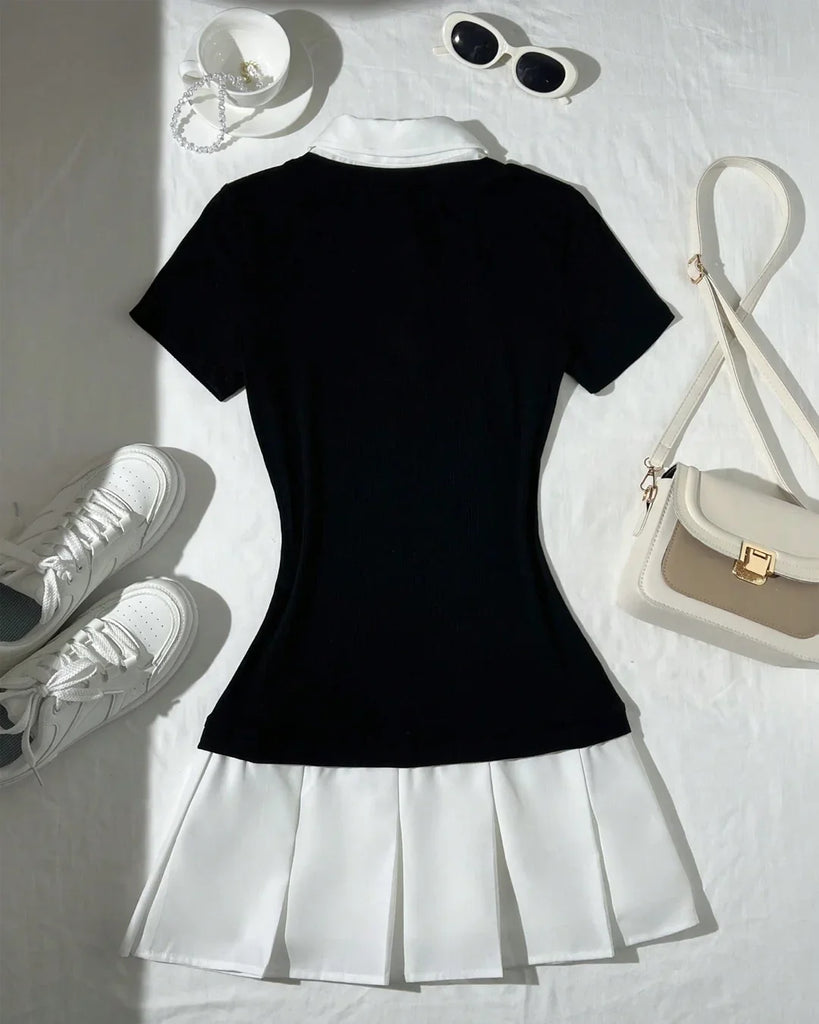 Back view of a Black and white pleated dress with a white collar, paired with white shoes and a matching purse.