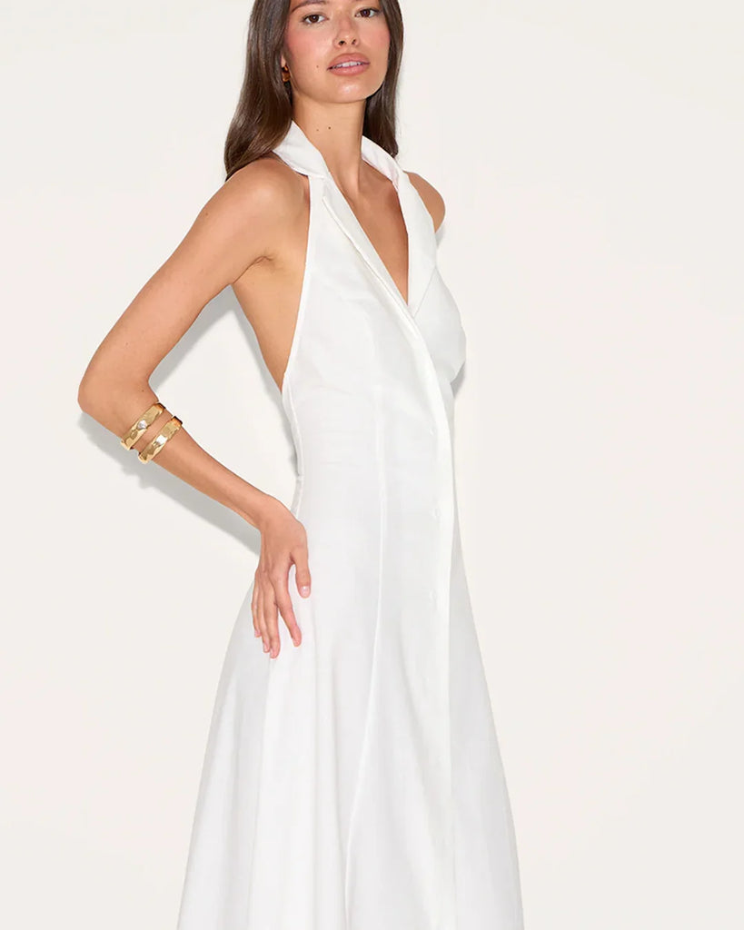 White halter neck maxi dress featuring a deep neckline and a front slit, elegant and stylish for formal occasions.