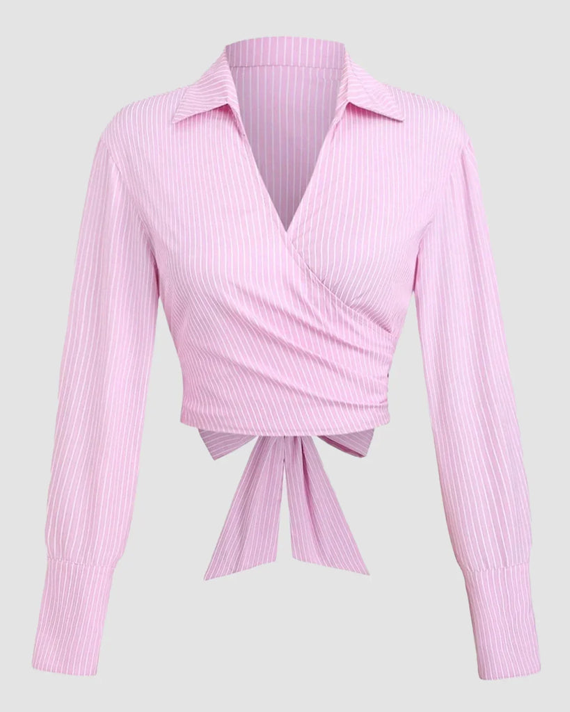 Pink long sleeve shirt featuring a bow tie at the front, designed with a wrap tie collar for a stylish look.
