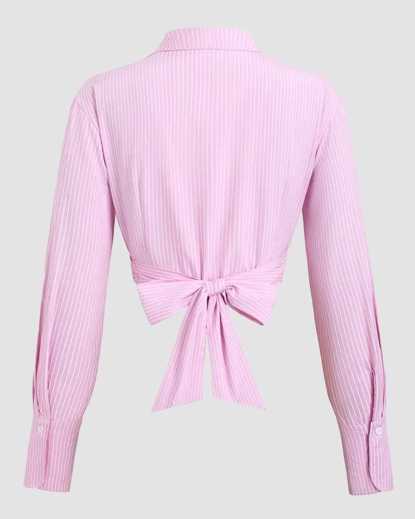 Back view of a Pink long sleeve shirt featuring a bow tie at the front, designed with a wrap tie collar for a stylish look.