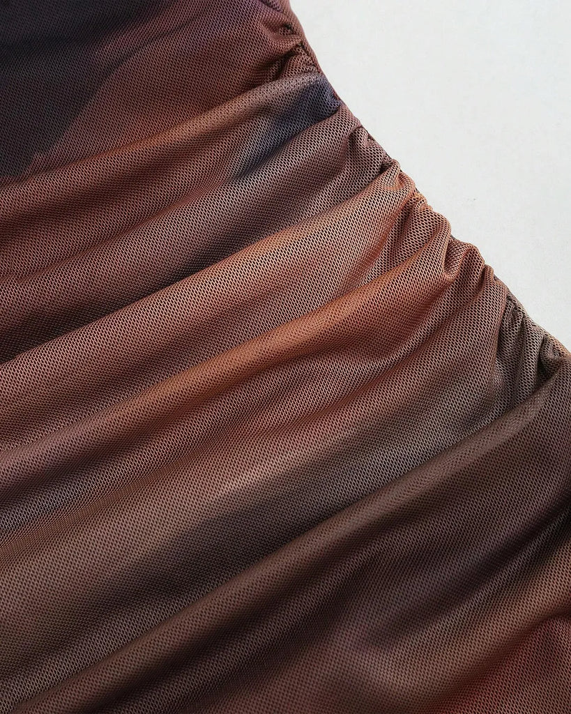 Closed view of a Ruched sheer mesh mermaid hem dress featuring a stylish brown and black print.