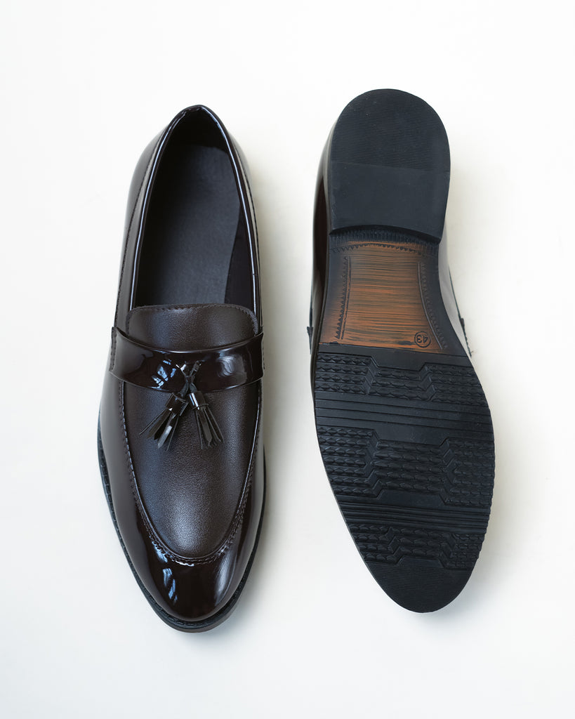 A  pair of black loafers with tassels.