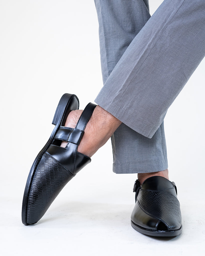 A man's feet in a pair of black shoes
