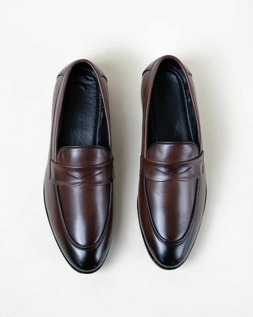 A pair of a brown Synthetic Leather loafers for men