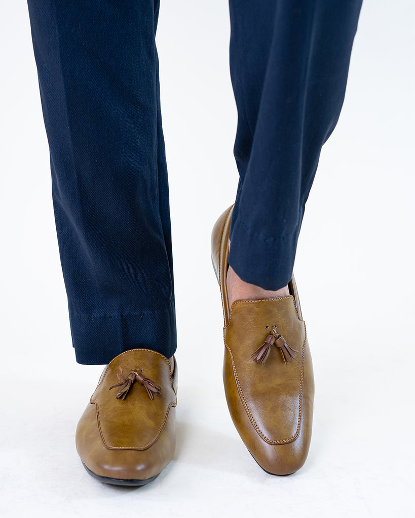 A model Wearing a pair of loafers