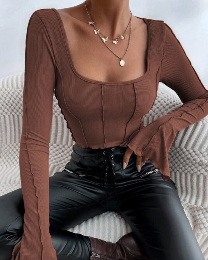 A Woman in Brown full sleeve and deep neck ribbed top