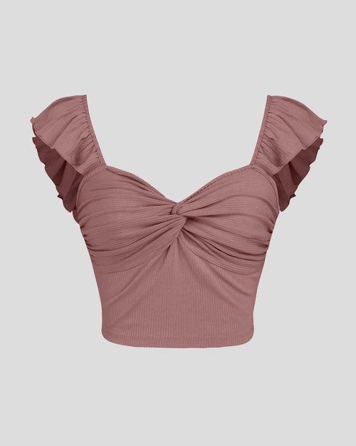 Front view of cropped vest ruffle top in blush pink, featuring delicate ruffles and a stylish design