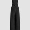 Black top and trouser set featuring a ruffled tube top and wide-leg pants, designed with a front button closure.