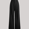 Front view of Black baggy pants with high rise waist, pleated front, wide leg fit, and smooth fabric for relaxed style.