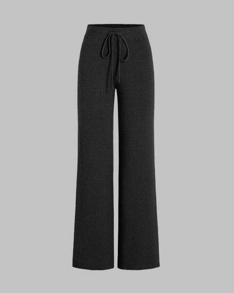 Front view of Black ribbed pants with high rise waist, drawstring front, wide leg fit, and soft lounge style silhouette.