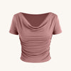 Pink off-the-shoulder top with short sleeves and a ruched neckline, showcasing a stylish and feminine design
