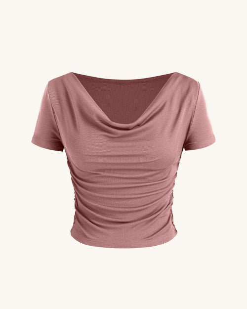 Pink off-the-shoulder top with short sleeves and a ruched neckline, showcasing a stylish and feminine design