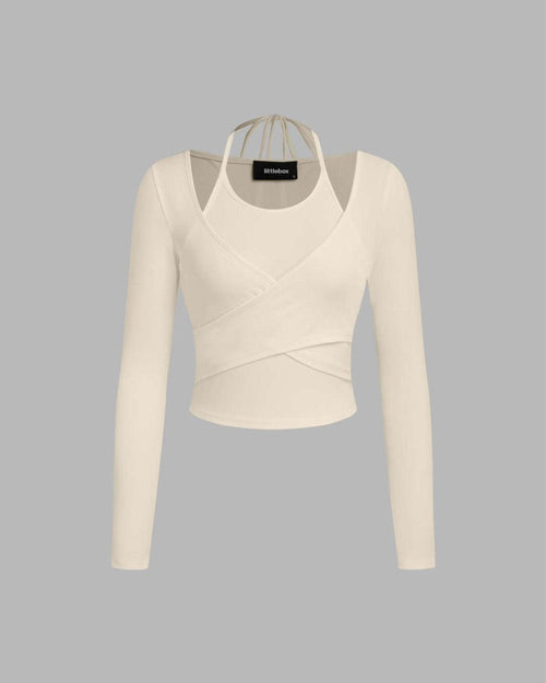 White knit cropped top with a solid wrap cut-out neck and full sleeves, displayed in apricot color.