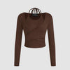 Front view of long-sleeve cropped top with a wrap cut-out neck, featuring a rib knit design in chocolate brown