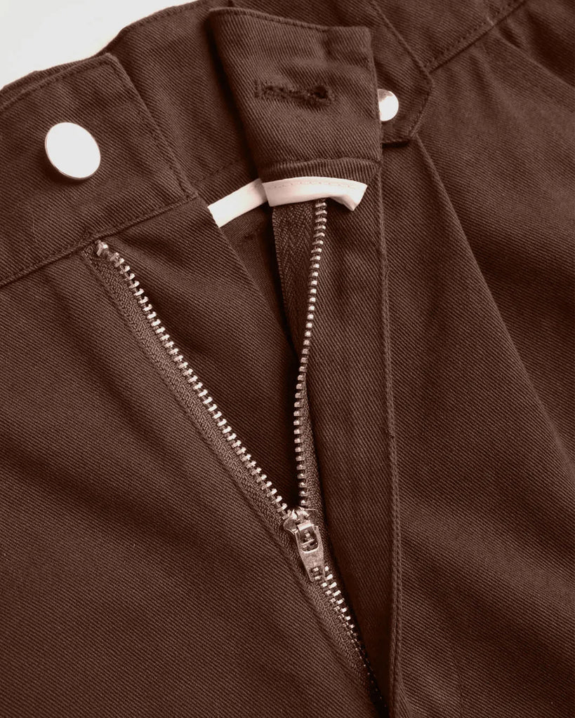 Zip of Y2K baggy fit women's cargo pants in brown and black, featuring pockets and zippers.