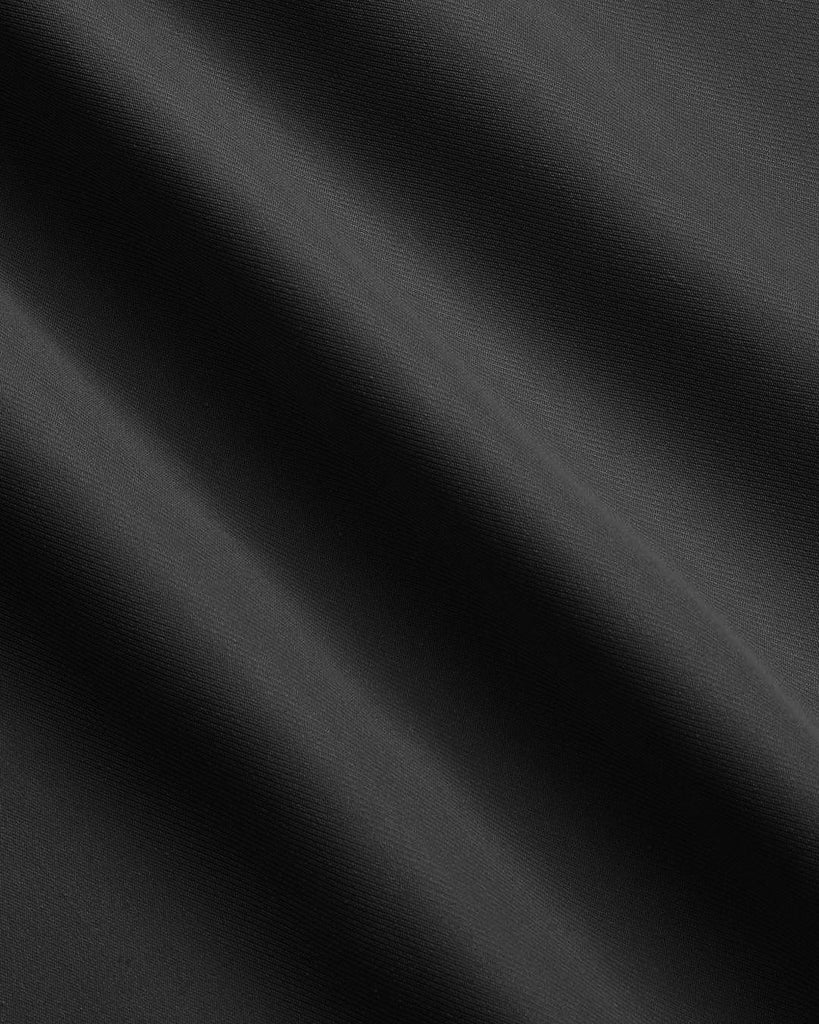 material close up view of A black skirt featuring a stylish side slit